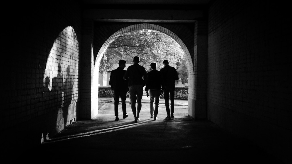 Rear view of silhouette people walking in corridor