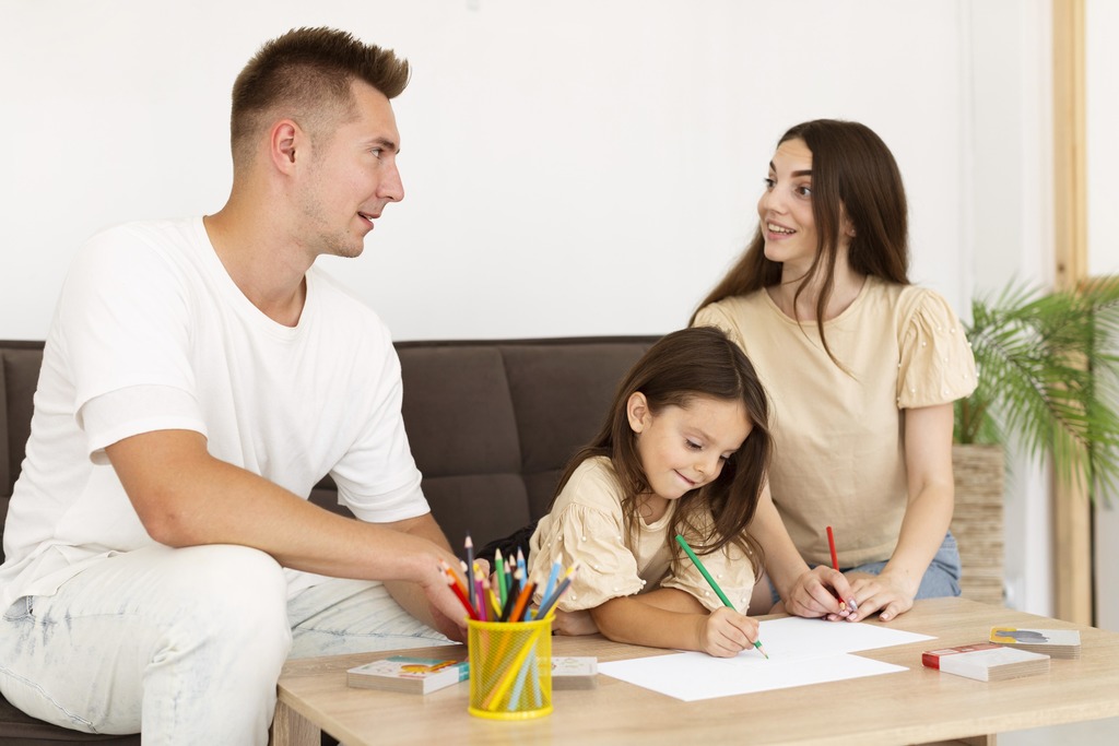 Family drawing together in the living room